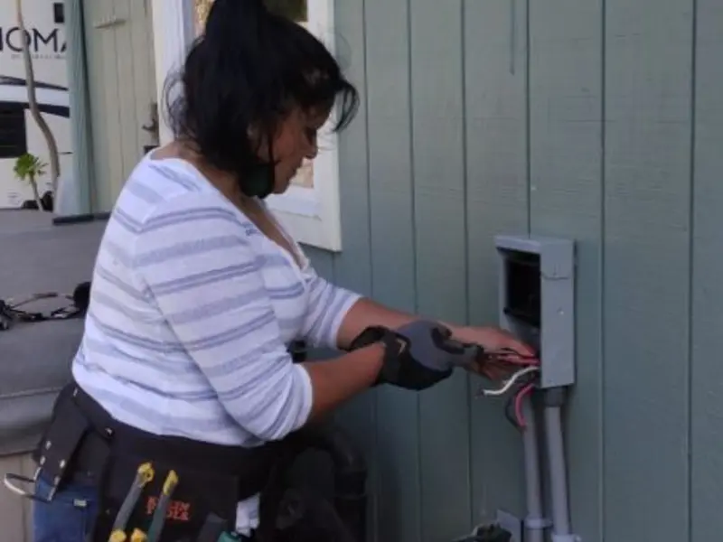 Licensed electrician wiring an exterior subpanel in Midway City